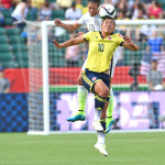 Carli Lloyd and Yoreli Rincón vie for the ball.